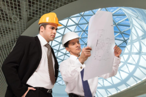 architect supervisor reviewing blueprints 488220 65927